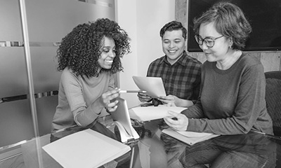 Three people in a meeting.