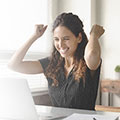 Woman smiling at a laptop